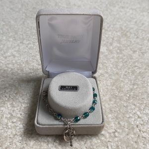 Emerald Bracelet: Crucifix, Mary, and “n” Charms